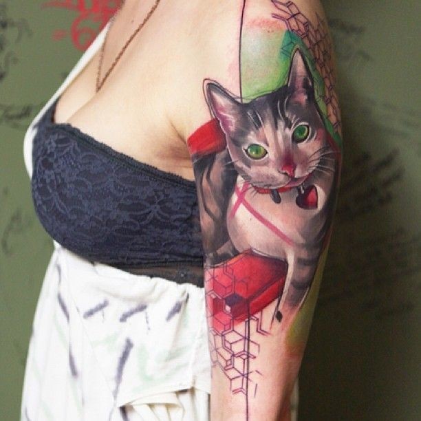 Realism style colored shoulder tattoo of cat with small red heart