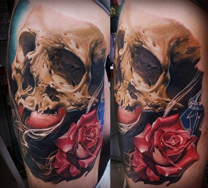 Realism style colored shoulder tattoo of human skull and rose
