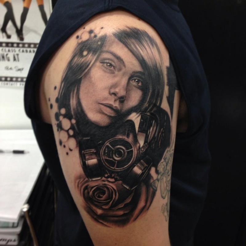 Realism style colored shoulder tattoo of  woman with gas mask