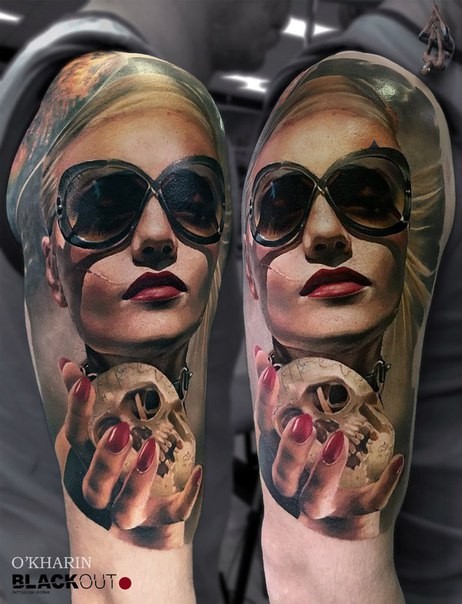 Realism style colored shoulder tattoo of woman with sun glasses and small skull