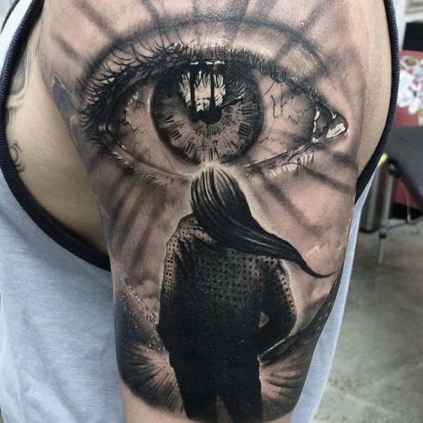 Realism style colored shoulder tattoo of human eye with woman figure