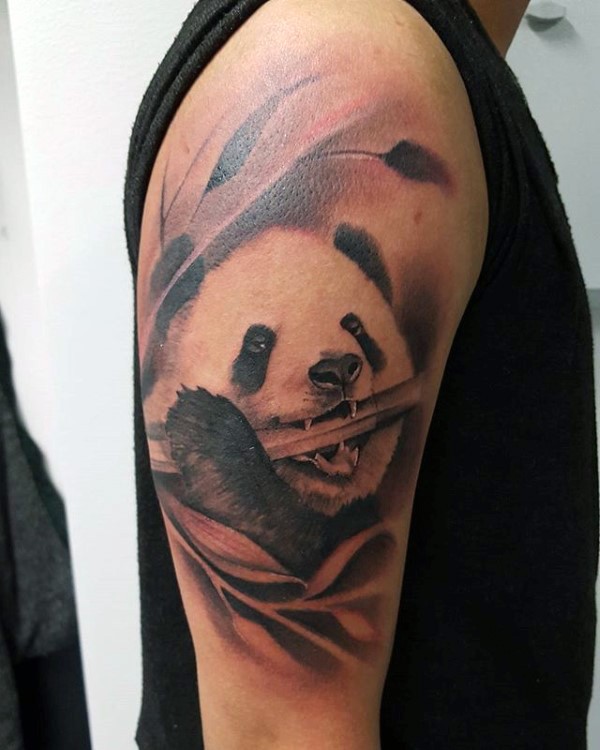 Realism style colored shoulder tattoo of panda bear with bamboo