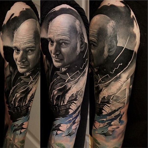 Realism style colored sleeve tattoo of man portrait
