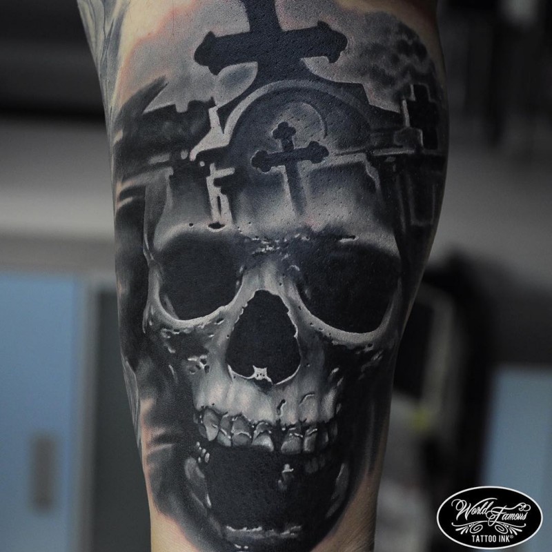Realism style colored tattoo of creepy human skull with cemetery and cross