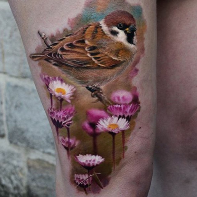 Realism style colored thigh tattoo of little bird with flowers