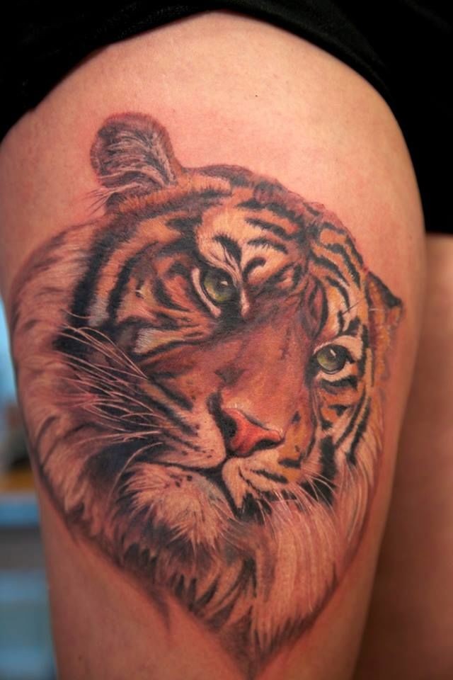 Realism style colored thigh tattoo of