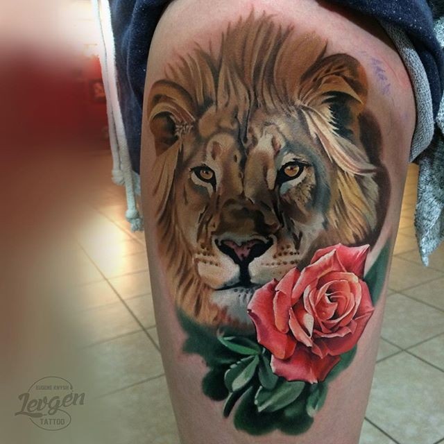 Realism style colored thigh tattoo of big lion and rose