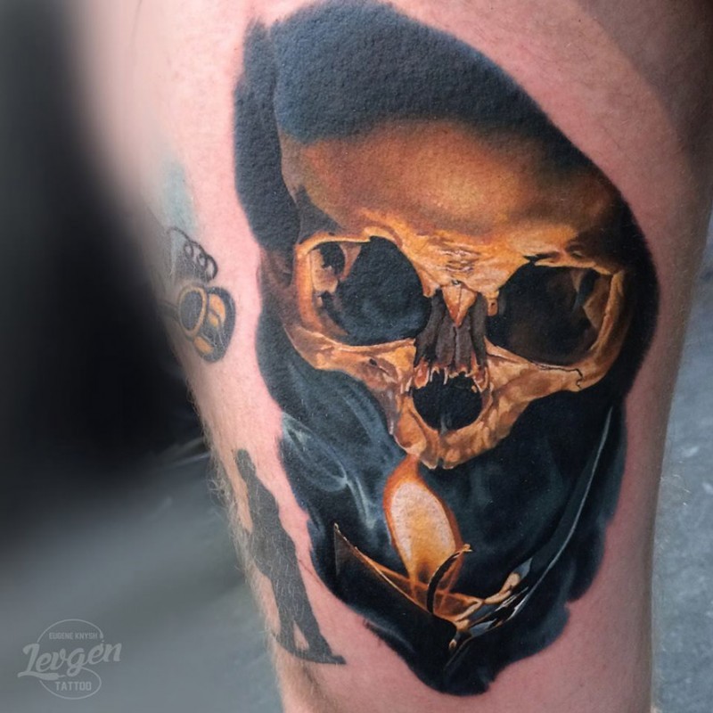 Realism style colored thigh tattoo of human skull with burning candle