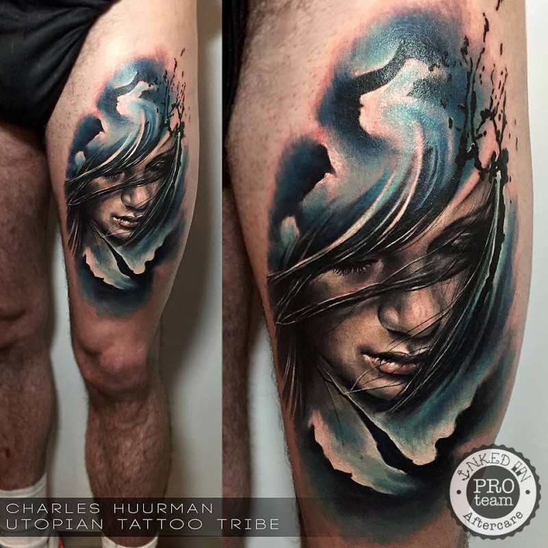 Realism style colored thigh tattoo of woman with waves