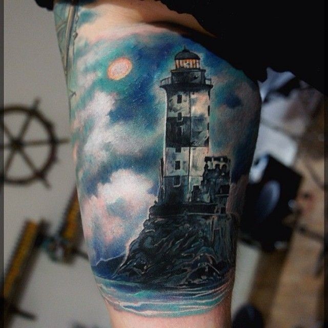 Realism style colorful old lighthouse tattoo on biceps