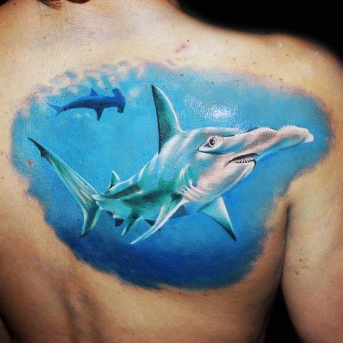 Realism style detailed and colored large hammerhead shark tattoo on back