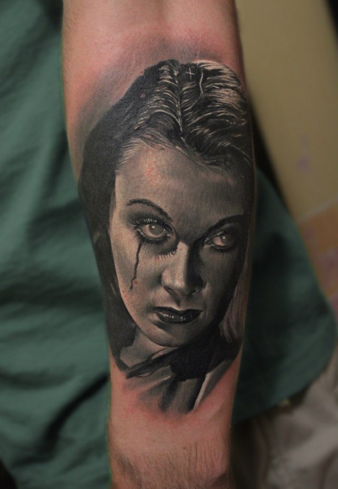 Realism style detailed arm tattoo of creepy looking woman