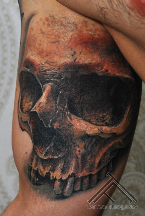 Realism style detailed biceps tattoo of human skull