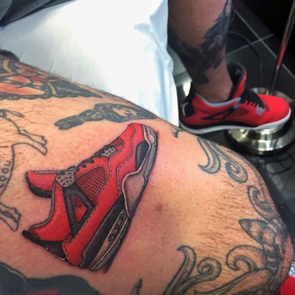 Realism style tattoo of sneakers with skates