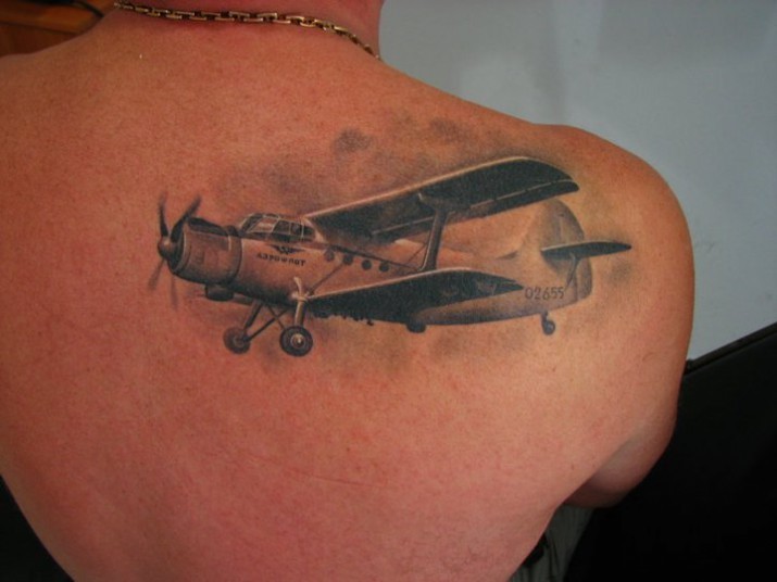 Realism style very detailed scapular tattoo of vintage plane