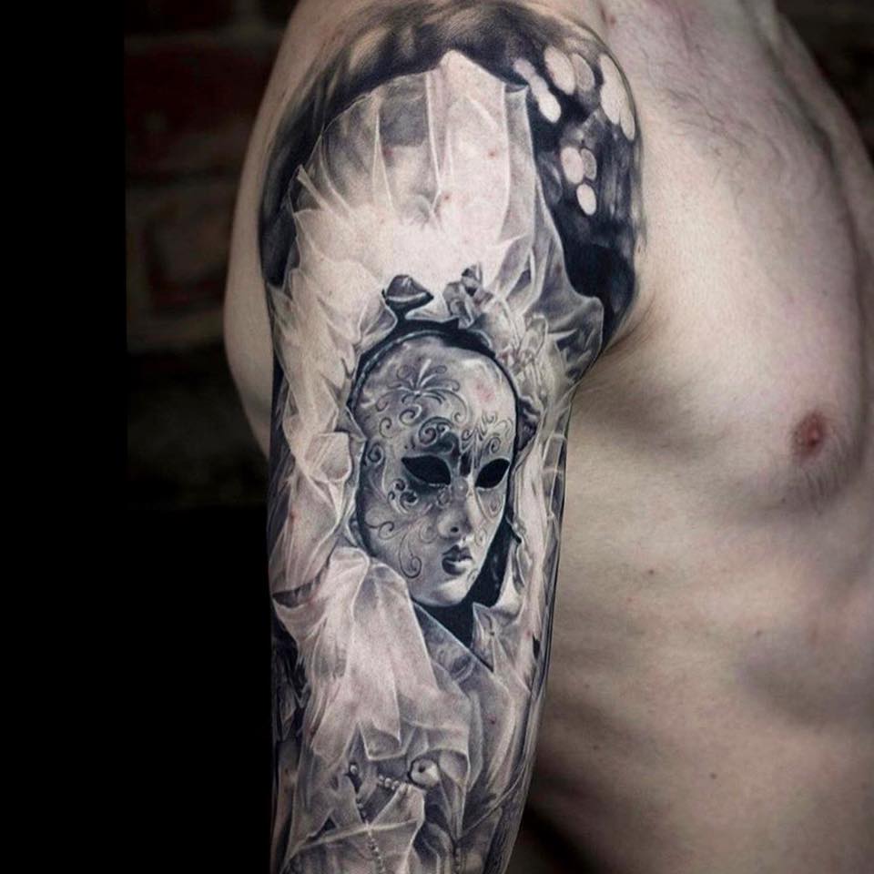 Realistic black and white  mask tattoo on shoulder