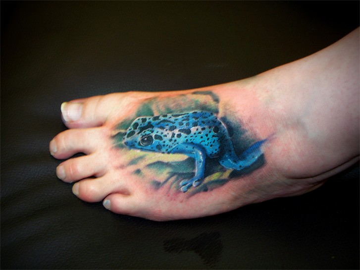 Realistic blue poisonous frog tattoo on foot