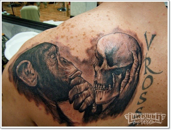Realistic chimpanzee and skull tattoo on back
