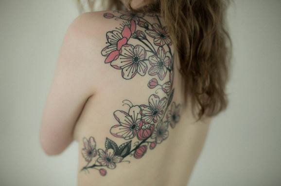 Realistic detailed cherry blossoms tattoo on back