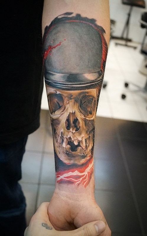 Realistic detailed skull in hat forearm tattoo