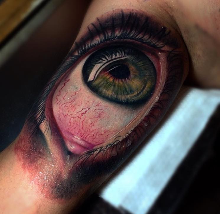 Realistic dreadful human eye tattoo on arm by Pedro Acosta
