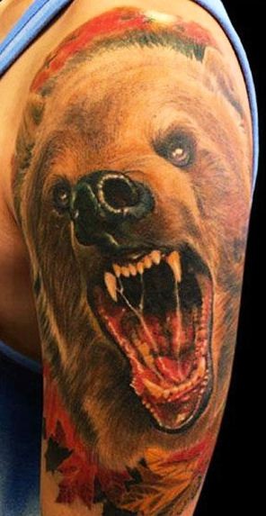 Realistic gnarling bear tattoo on shoulder