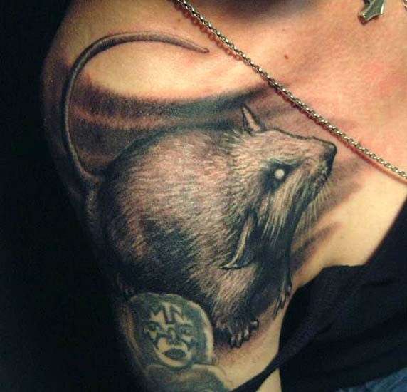 Realistic gray-ink rodent tattoo on shoulder