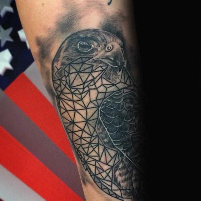 Realistic hawk tattoo with geometrical elements on biceps