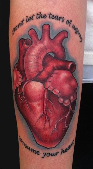 Tatuaggio realistico colorato sul braccio il cuore rosso & la scritta
