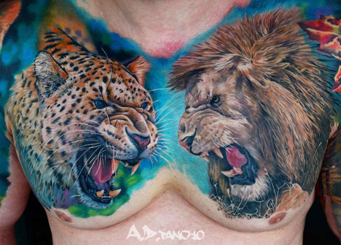 Realistic leopard and lion heads tattoo on chest by pancho