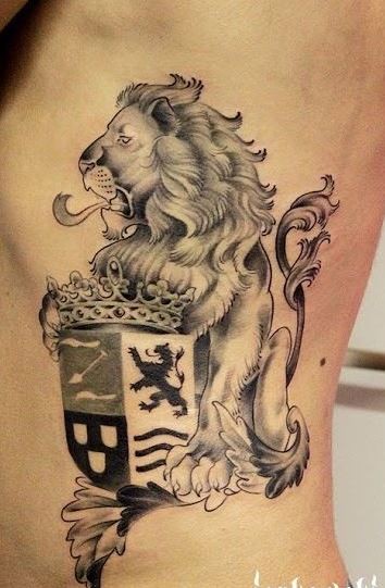 Realistic lion with family crest and crown tattoo on ribs