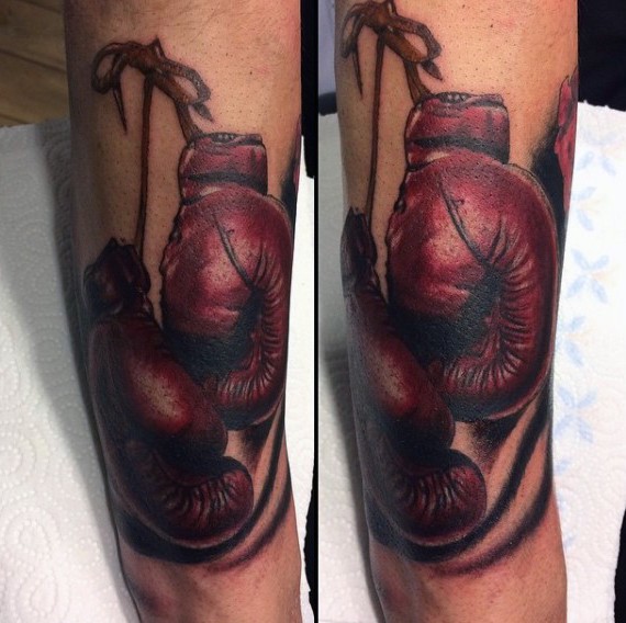 Realistic looking big colored old boxers gloves tattoo on arm