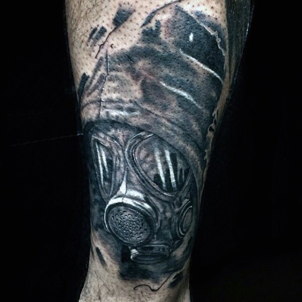 Realistic looking black and white man in gas mask tattoo on leg