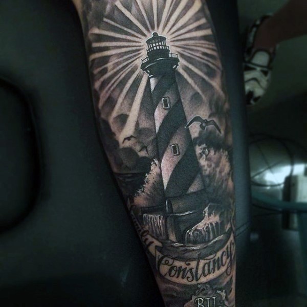 Realistic looking black ink big lighthouse with lettering tattoo on arm