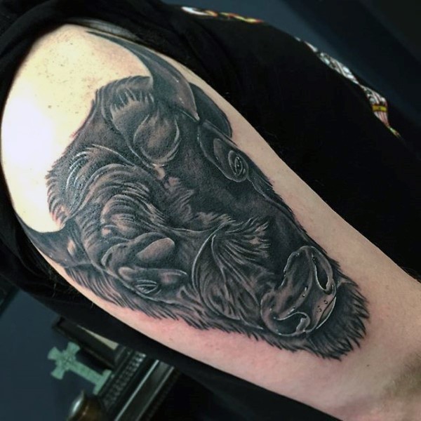 Realistic looking black ink shoulder tattoo of big bulls head