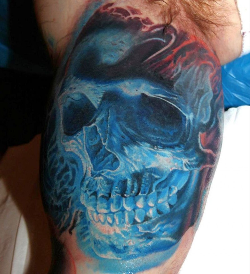 Realistic looking colored biceps tattoo of blue skull