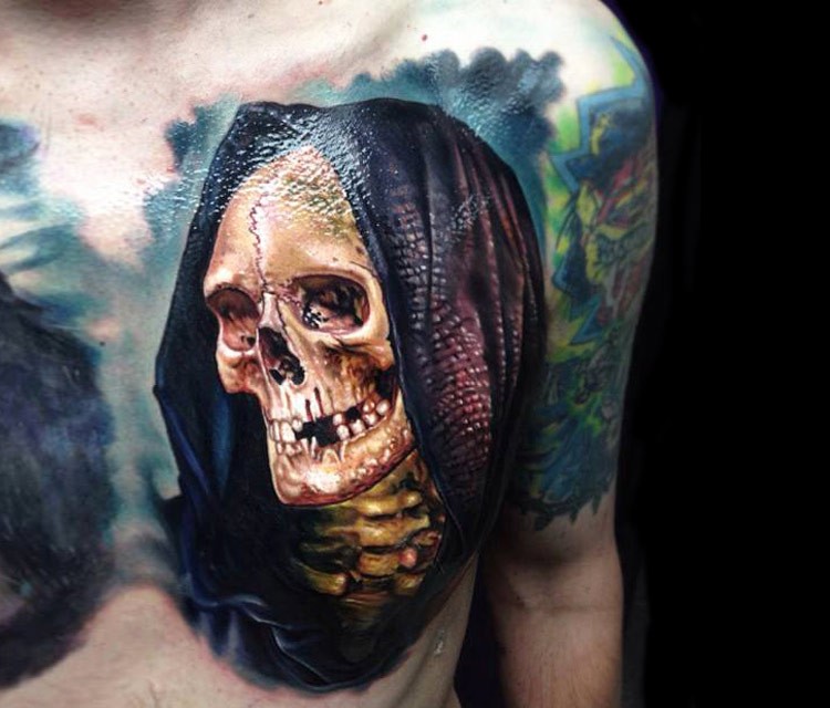 Realistic looking colored chest tattoo of skeleton with hood
