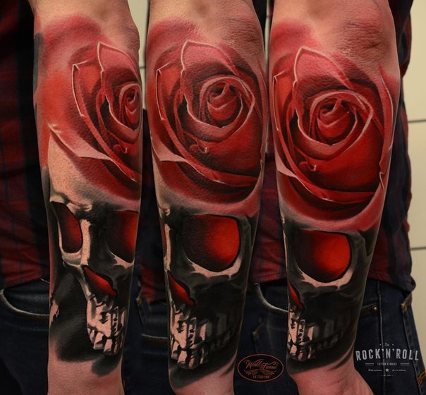 Realistic looking colored hand tattoo of human skull with rose