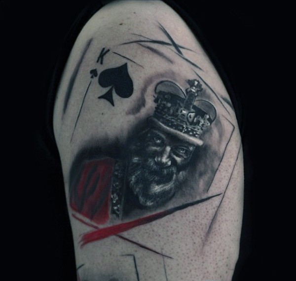 Realistic looking colored shoulder tattoo of king card