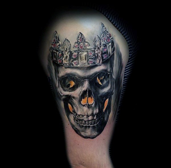 Realistic looking colored shoulder tattoo of human skull with crown