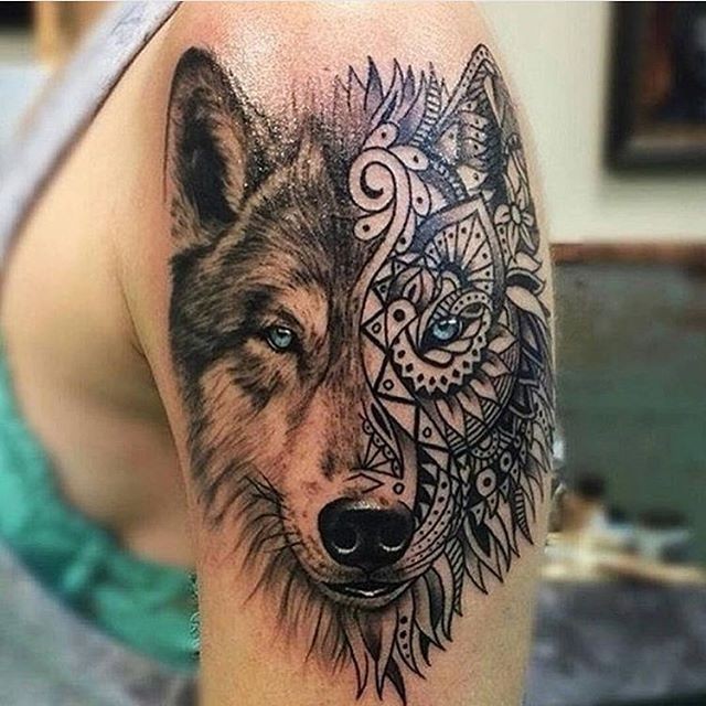 Realistic looking colored shoulder tattoo of wolf head with ornamental mask