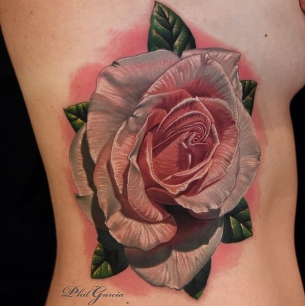 Realistic looking colored side tattoo of big rose with leaves