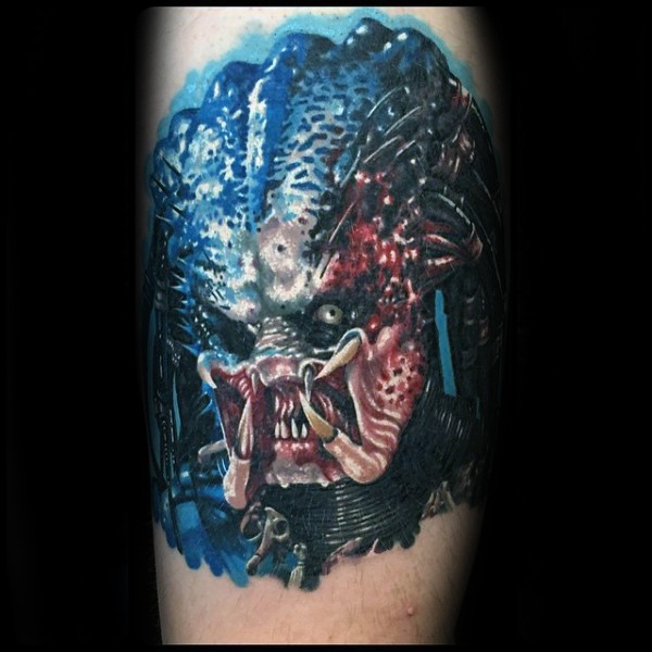Realistic looking colored tattoo of evil Predator face