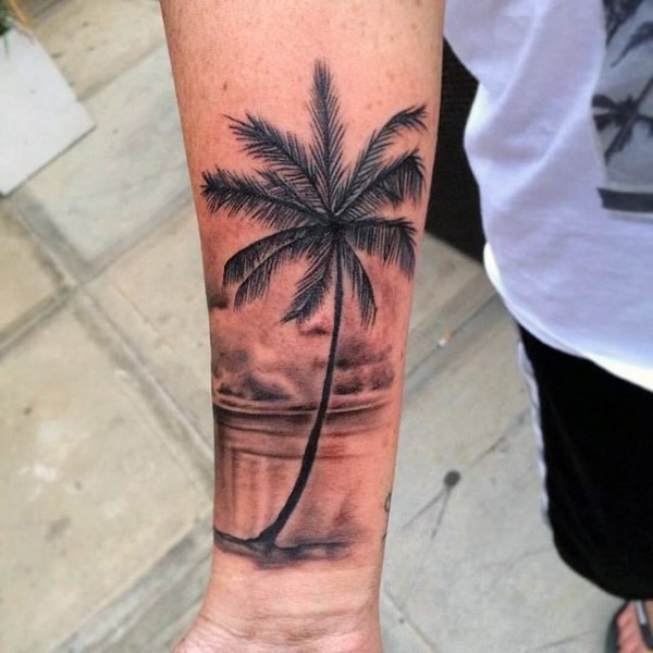 Realistic looking detailed black ink palm tree tattoo on wrist