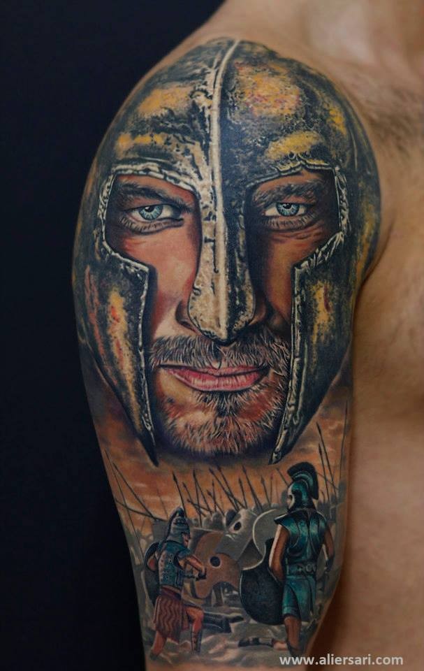 Realistic looking shoulder tattoo of medieval knight face with soldiers