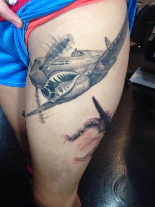 Realistic looking thigh tattoo of WW2 plane