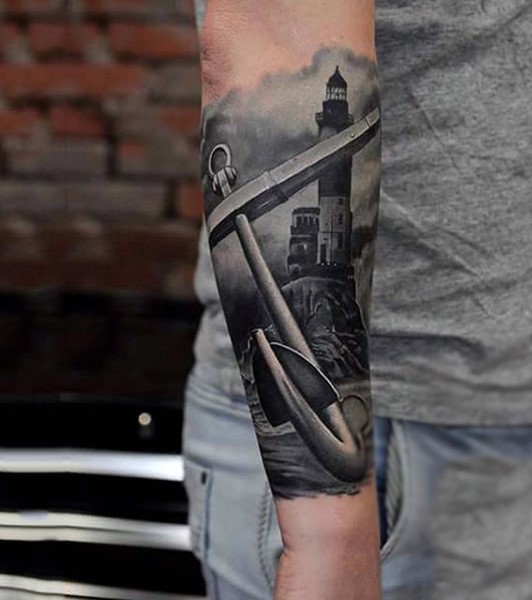 Realistic photo like black and white old anchor with light house tattoo on arm