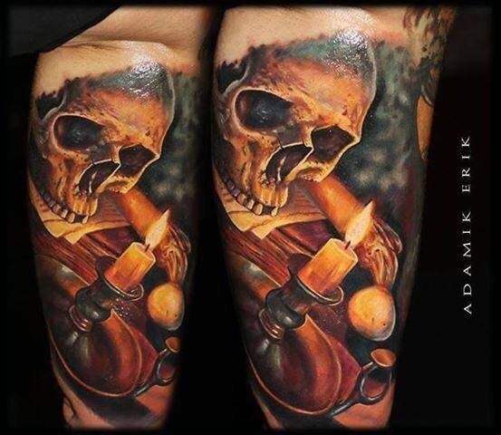 Realistic style colored human skull tattoo on arm combined with burning candle