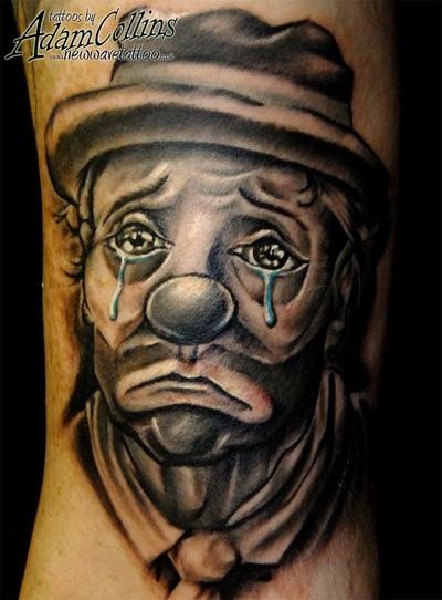 Realistic tearful clown tattoo