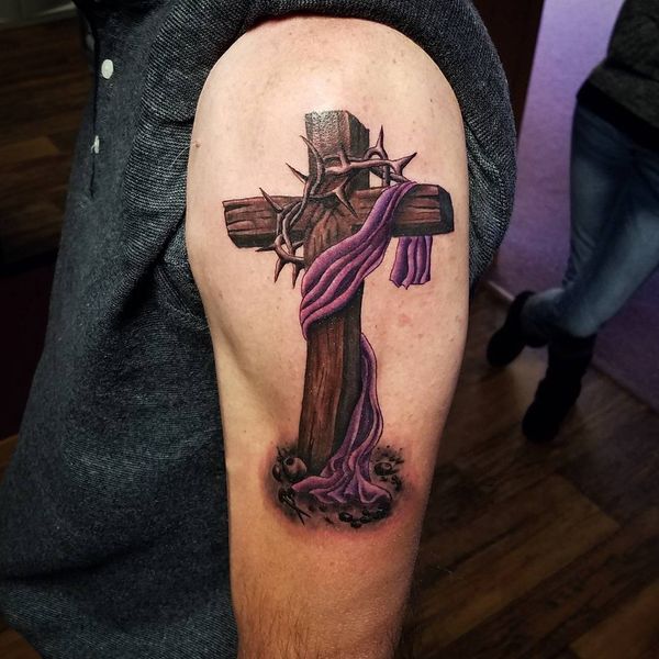 Realistic wooden cross with barbed wire and purple cloth tattoo